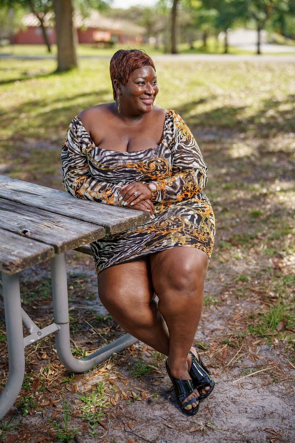 Bbw Big Black Beautiful Model Sitting On A Park Bench Outdoors Stock Photo Image Of Hair